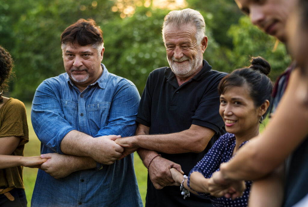 A group of volunteers cross-holding hands.